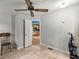 Bedroom featuring laminate floors, neutral paint and ceiling fan with view into the kitchen at 22535 Sw 117Th St, Dunnellon, FL 34431