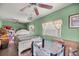 Comfortable bedroom with green walls, wood floors, abundant natural light, and ample space for furniture and relaxation at 22535 Sw 117Th St, Dunnellon, FL 34431
