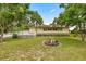 Charming home featuring mature landscaping, a flamingo water feature, and inviting deck at 22535 Sw 117Th St, Dunnellon, FL 34431