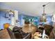 Open living room featuring hardwood floors, ample natural light, and a spacious layout ideal for gatherings at 22535 Sw 117Th St, Dunnellon, FL 34431