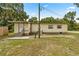 Rear exterior of home; shows vinyl siding, utility access, and a small covered porch at 22535 Sw 117Th St, Dunnellon, FL 34431