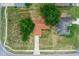 An aerial view of the home showing the roof, yard, driveway, and mature trees at 263 Chestnut Rd, Ocala, FL 34480