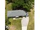 Aerial shot of a well-maintained home featuring a long driveway and a lush, green yard with mature trees at 2810 Se Lake Weir Ave, Ocala, FL 34471