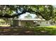 The backyard features mature trees providing shade and a secluded outdoor area at 2810 Se Lake Weir Ave, Ocala, FL 34471