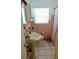 Bathroom with a pedestal sink and tiled shower at 2810 Se Lake Weir Ave, Ocala, FL 34471