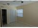 Bedroom with a window and closet, beige walls and tile floor at 2810 Se Lake Weir Ave, Ocala, FL 34471