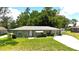 Charming single-story home boasts a well-manicured lawn, colorful landscaping, and a welcoming front entrance at 2810 Se Lake Weir Ave, Ocala, FL 34471