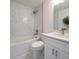 Modern bathroom featuring white marble tile, new fixtures, a shower-tub combo, and a neutral color palette at 3527 Sw 149Th Ter, Ocala, FL 34481