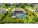 Aerial view of a home featuring a screened-in pool, spa, solar panels, and meticulously landscaped backyard at 3986 Se 43Rd Cir, Ocala, FL 34480