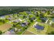 Community aerial shot showcasing many homes, green spaces, and swimming pools in a quiet neighborhood at 3986 Se 43Rd Cir, Ocala, FL 34480