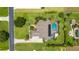 Aerial view of the backyard featuring a sparkling pool, screened-in patio, and lush landscaping at 3986 Se 43Rd Cir, Ocala, FL 34480