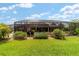 Screened backyard pool and patio area featuring lush landscaping and outdoor seating at 3986 Se 43Rd Cir, Ocala, FL 34480