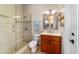 Well-lit bathroom with glass-enclosed shower and single vanity at 3986 Se 43Rd Cir, Ocala, FL 34480