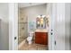 Well-lit bathroom with glass-enclosed shower and single vanity at 3986 Se 43Rd Cir, Ocala, FL 34480