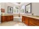 Bright bathroom featuring a soaking tub, dual vanities, and arched windows with plantation shutters at 3986 Se 43Rd Cir, Ocala, FL 34480