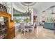 Open-concept dining area with backyard pool view, chandelier lighting, and easy access to living spaces at 3986 Se 43Rd Cir, Ocala, FL 34480