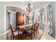 Charming dining room with a chandelier and a hutch cabinet at 3986 Se 43Rd Cir, Ocala, FL 34480