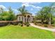 Beautiful home featuring a well-manicured lawn, palm trees, and a pathway leading to the front door at 3986 Se 43Rd Cir, Ocala, FL 34480