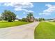 View of a lush front yard with a circular drive leading to a well-maintained home at 3986 Se 43Rd Cir, Ocala, FL 34480
