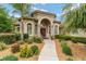 Stunning single-story home featuring a charming red door, lush landscaping, and inviting curb appeal at 3986 Se 43Rd Cir, Ocala, FL 34480