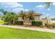 Exterior of a home with palm trees, green lawn, and a well manicured landscape at 3986 Se 43Rd Cir, Ocala, FL 34480