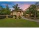 Beautiful home exterior with lush landscaping, mature palm trees, and manicured lawn at 3986 Se 43Rd Cir, Ocala, FL 34480