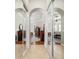 A hallway featuring tile flooring and mirrored closet doors leading to the main bedroom at 3986 Se 43Rd Cir, Ocala, FL 34480