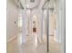 Hallway with tile flooring and mirrored closet doors leading to a bathroom at 3986 Se 43Rd Cir, Ocala, FL 34480