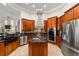 Spacious kitchen featuring custom cabinets, center island, and stainless-steel appliances at 3986 Se 43Rd Cir, Ocala, FL 34480