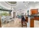 Open-concept kitchen and dining area featuring granite counters, tile floors, and coffered ceilings at 3986 Se 43Rd Cir, Ocala, FL 34480