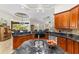 A kitchen shows wood cabinetry, granite countertops, and stainless steel appliances at 3986 Se 43Rd Cir, Ocala, FL 34480