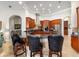 Kitchen with dark granite countertops, seated bar, and stainless-steel appliances at 3986 Se 43Rd Cir, Ocala, FL 34480
