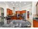 Open kitchen features custom cabinetry, granite countertops, and stainless-steel appliances at 3986 Se 43Rd Cir, Ocala, FL 34480