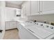 Laundry room includes washer, dryer, sink, and ample storage space at 3986 Se 43Rd Cir, Ocala, FL 34480