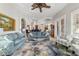 Spacious living room featuring tray ceilings, ceiling fan, and lots of natural light at 3986 Se 43Rd Cir, Ocala, FL 34480