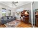 Cozy living room with desk, hardwood floors, ceiling fan, and ample natural light at 3986 Se 43Rd Cir, Ocala, FL 34480