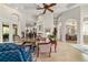 Spacious living room featuring tile flooring, ceiling fan, and ample natural light at 3986 Se 43Rd Cir, Ocala, FL 34480