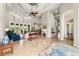 Bright living room featuring tile floors, an elegant ceiling fan, and plenty of natural light at 3986 Se 43Rd Cir, Ocala, FL 34480