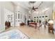 Open concept living room with tile flooring, architectural details, and a view to the kitchen at 3986 Se 43Rd Cir, Ocala, FL 34480