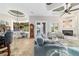 Open living areas featuring views to the kitchen, dining nook, fireplace, and access to backyard patio at 3986 Se 43Rd Cir, Ocala, FL 34480