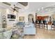 Open concept living area with kitchen bar, fireplace, and ample natural light at 3986 Se 43Rd Cir, Ocala, FL 34480