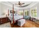 The main bedroom showcases hardwood floors, a ceiling fan, and bay windows with plantation shutters at 3986 Se 43Rd Cir, Ocala, FL 34480