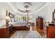 The main bedroom boasts hardwood floors, a ceiling fan, and bay windows with plantation shutters at 3986 Se 43Rd Cir, Ocala, FL 34480