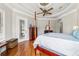 The main bedroom boasts hardwood floors, a ceiling fan, and a door leading to the lanai at 3986 Se 43Rd Cir, Ocala, FL 34480