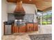 Outdoor kitchen with stainless steel grill, sink, and mini refrigerator for easy outdoor entertaining at 3986 Se 43Rd Cir, Ocala, FL 34480