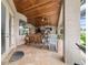 Covered patio with a cozy seating area, dining table, and outdoor kitchen, perfect for relaxation at 3986 Se 43Rd Cir, Ocala, FL 34480