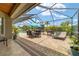 The spacious screened-in patio is perfect for outdoor dining, relaxation, and features a furnished outdoor setting at 3986 Se 43Rd Cir, Ocala, FL 34480