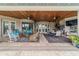Expansive covered patio with multiple seating areas, an outdoor kitchen, and serene views of the pool at 3986 Se 43Rd Cir, Ocala, FL 34480