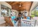 Relaxing covered patio with comfortable seating, a fire pit, and views of the outdoor kitchen and pool at 3986 Se 43Rd Cir, Ocala, FL 34480