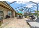 Spacious screened-in patio offers an ideal setting for outdoor dining and relaxing, fully furnished with outdoor cooking at 3986 Se 43Rd Cir, Ocala, FL 34480